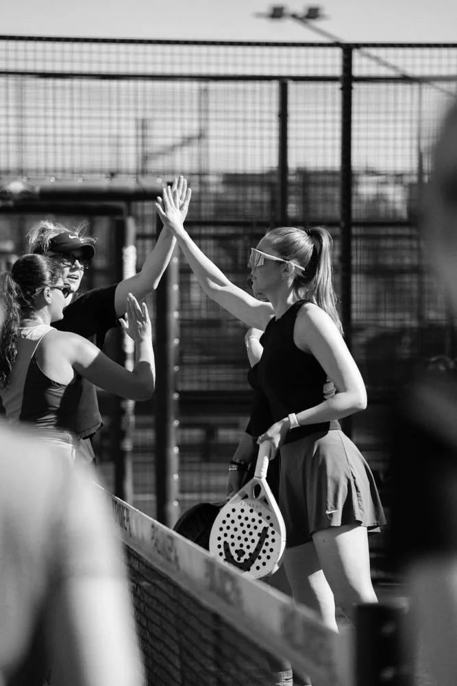 Padel players at the net, black and white
