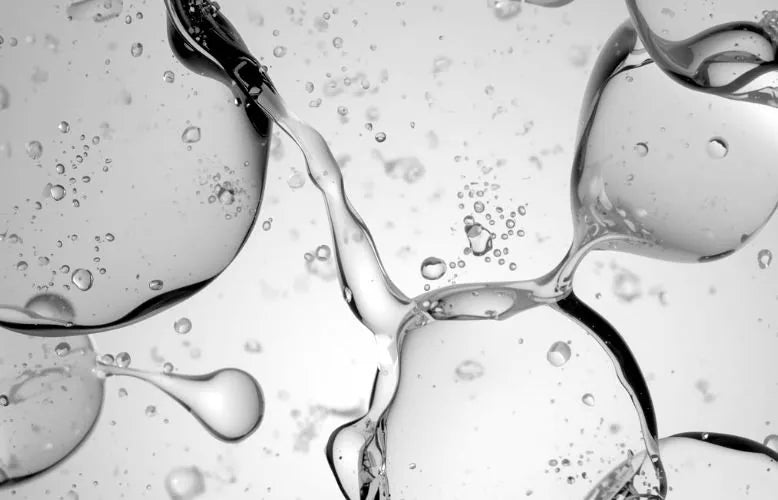 Clear liquid forming bubbles, black and white